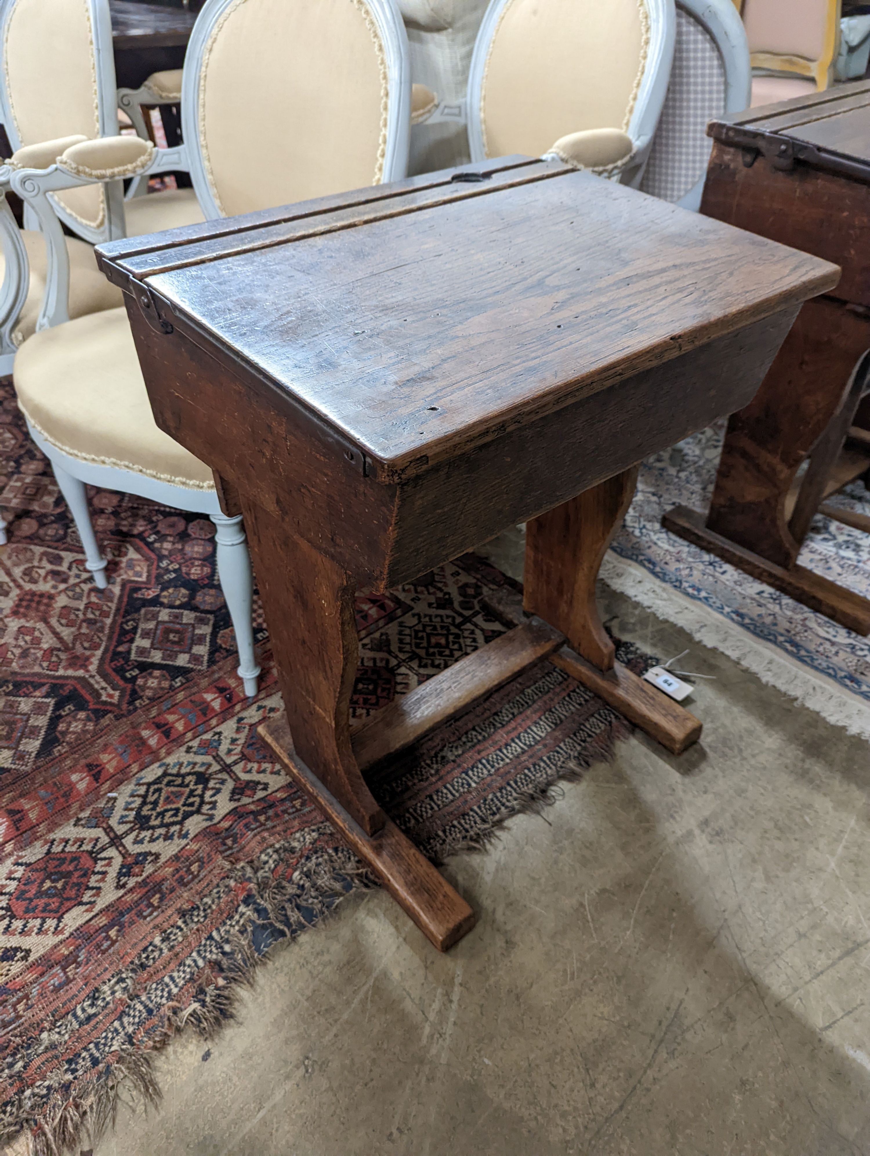 A vintage oak student's desk, width 57cm, depth 46cm, height 71cm with an elm and beech chair